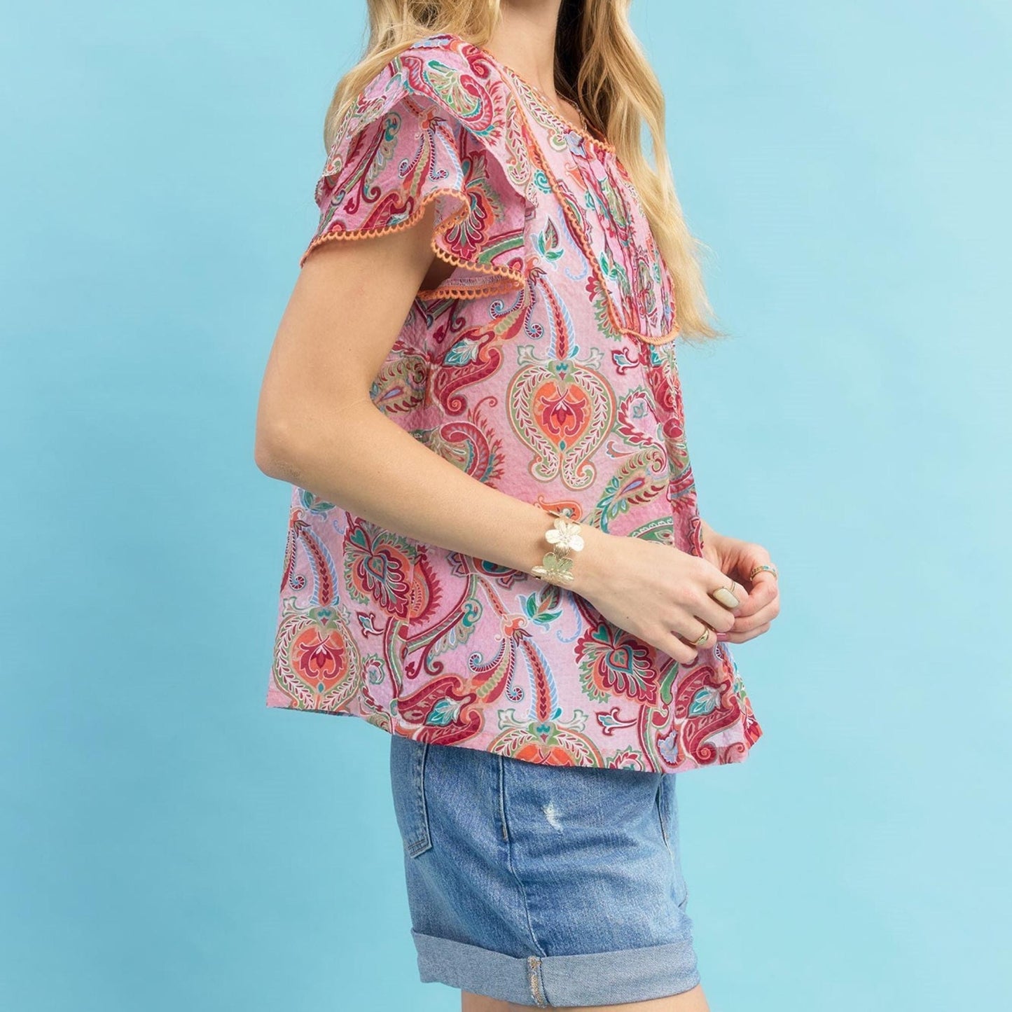 Side profile highlighting the playful ruffle sleeves and relaxed fit of the Umgee top.
