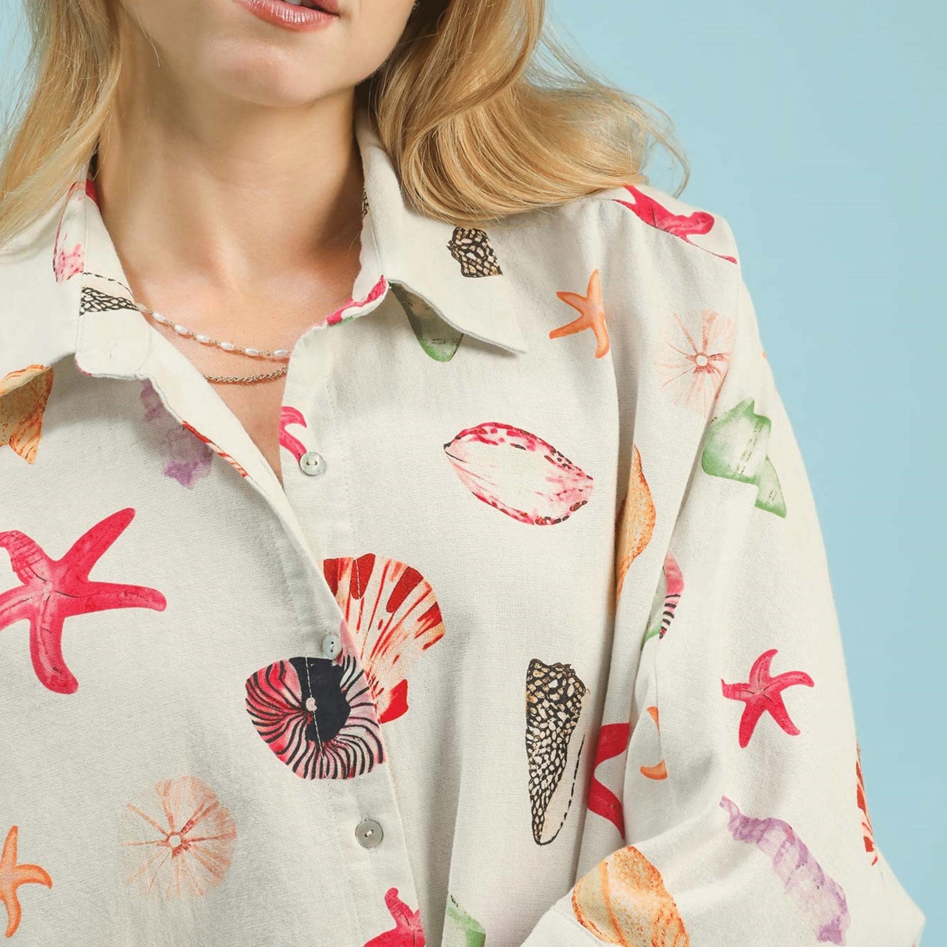 Close-up of the button-down front and the charming seashell and starfish print details.