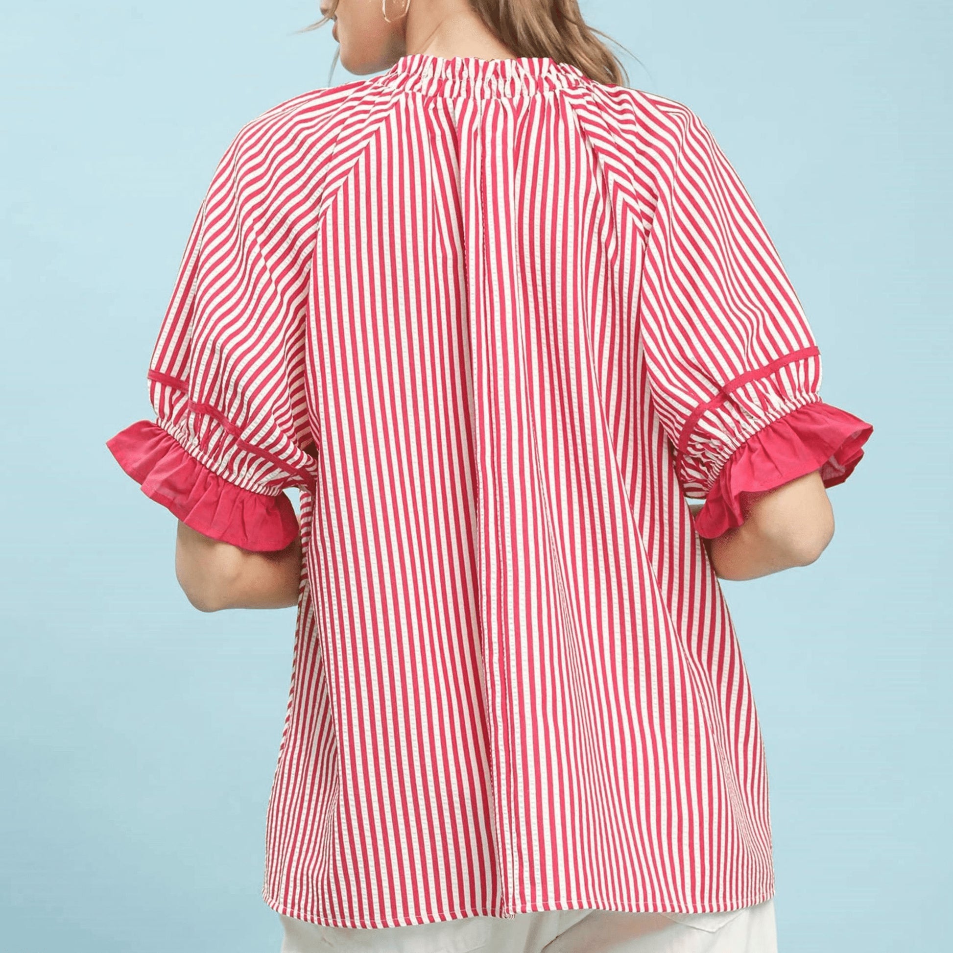 Back view of the raspberry stripe blouse highlighting the relaxed, flowy fit.