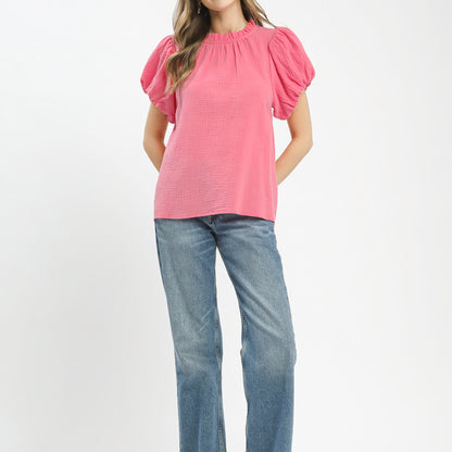Lifestyle shot of the pink ruffle neck boho top for an effortless daytime look.