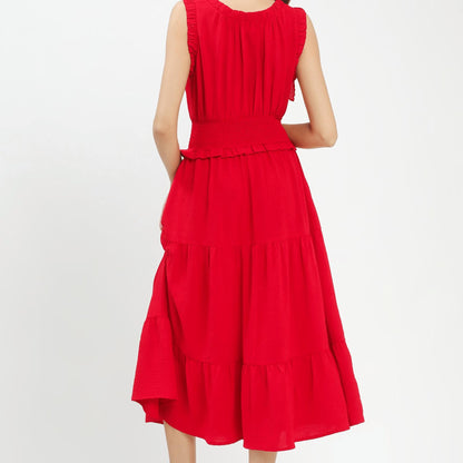 Back view of the vibrant red tiered dress highlighting the midi length and silhouette.