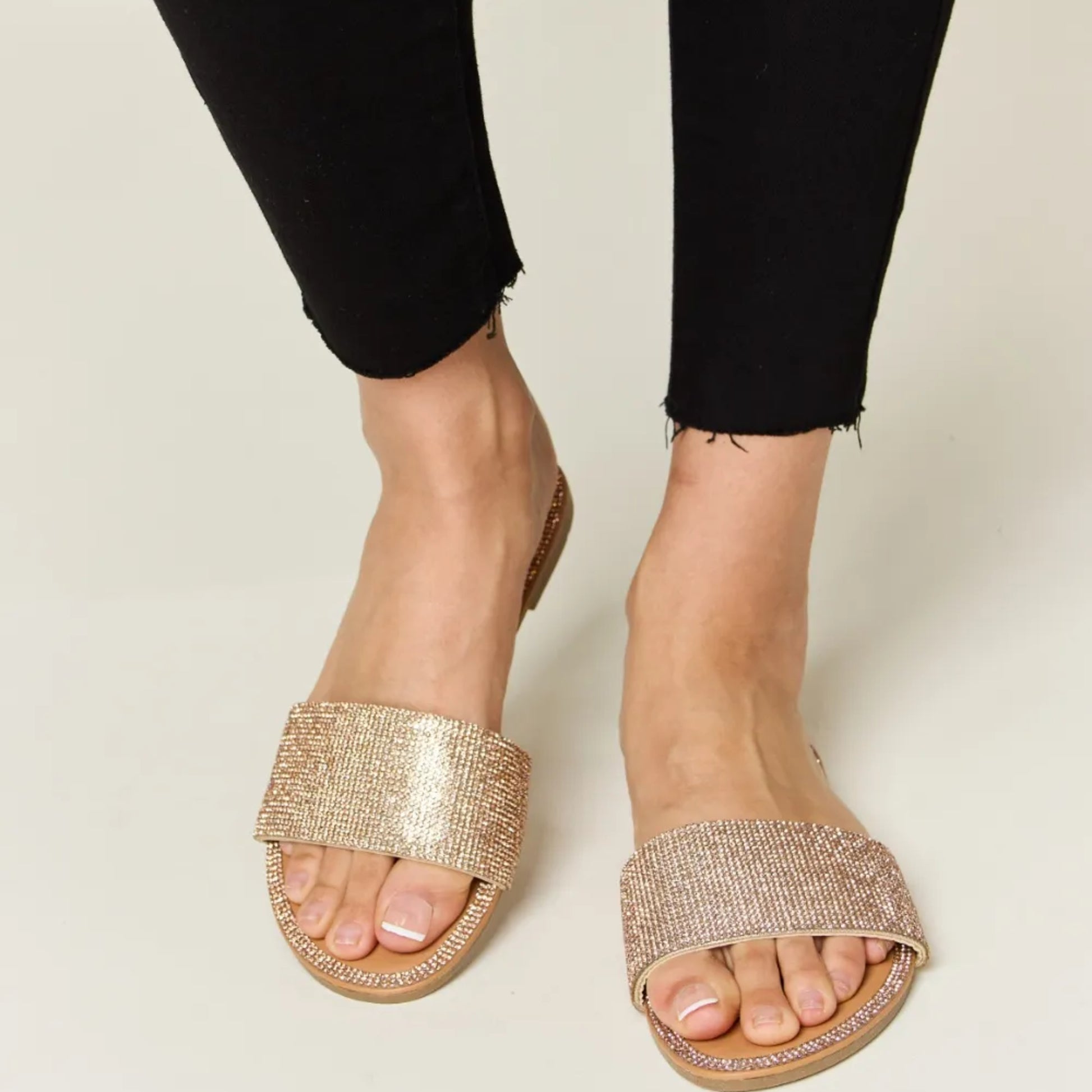 Top-down view of the elegant rose gold footbed and sparkling toe strap.