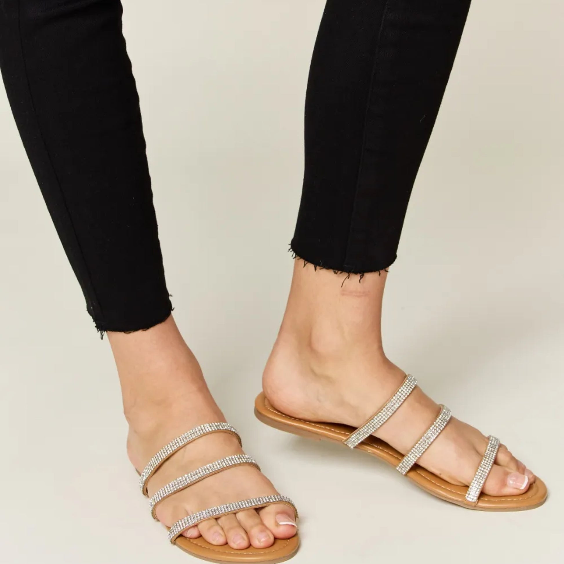Top-down view of the elegant three-strap design and tan footbed.