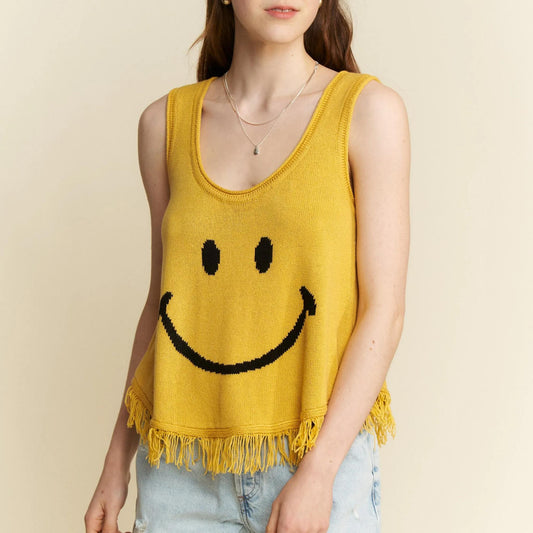 Lifestyle view of the yellow smiley tank styled with denim shorts for summer.