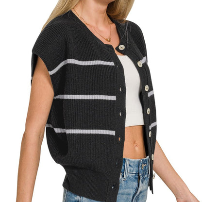 Woman wearing a black cardigan with white stripes on a white, side view background