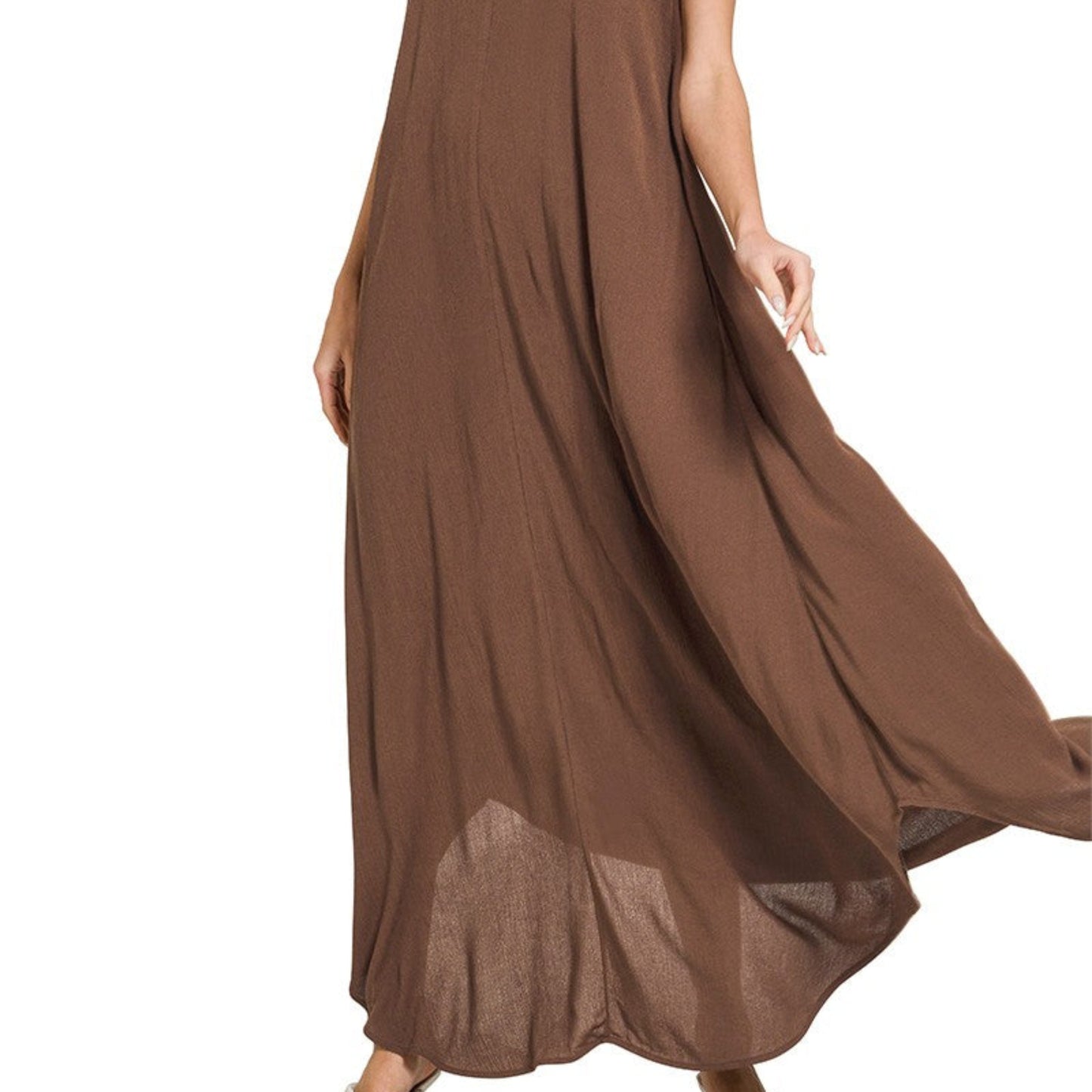 Close-up highlighting the side slit detail on the flowy brown woven maxi dress.