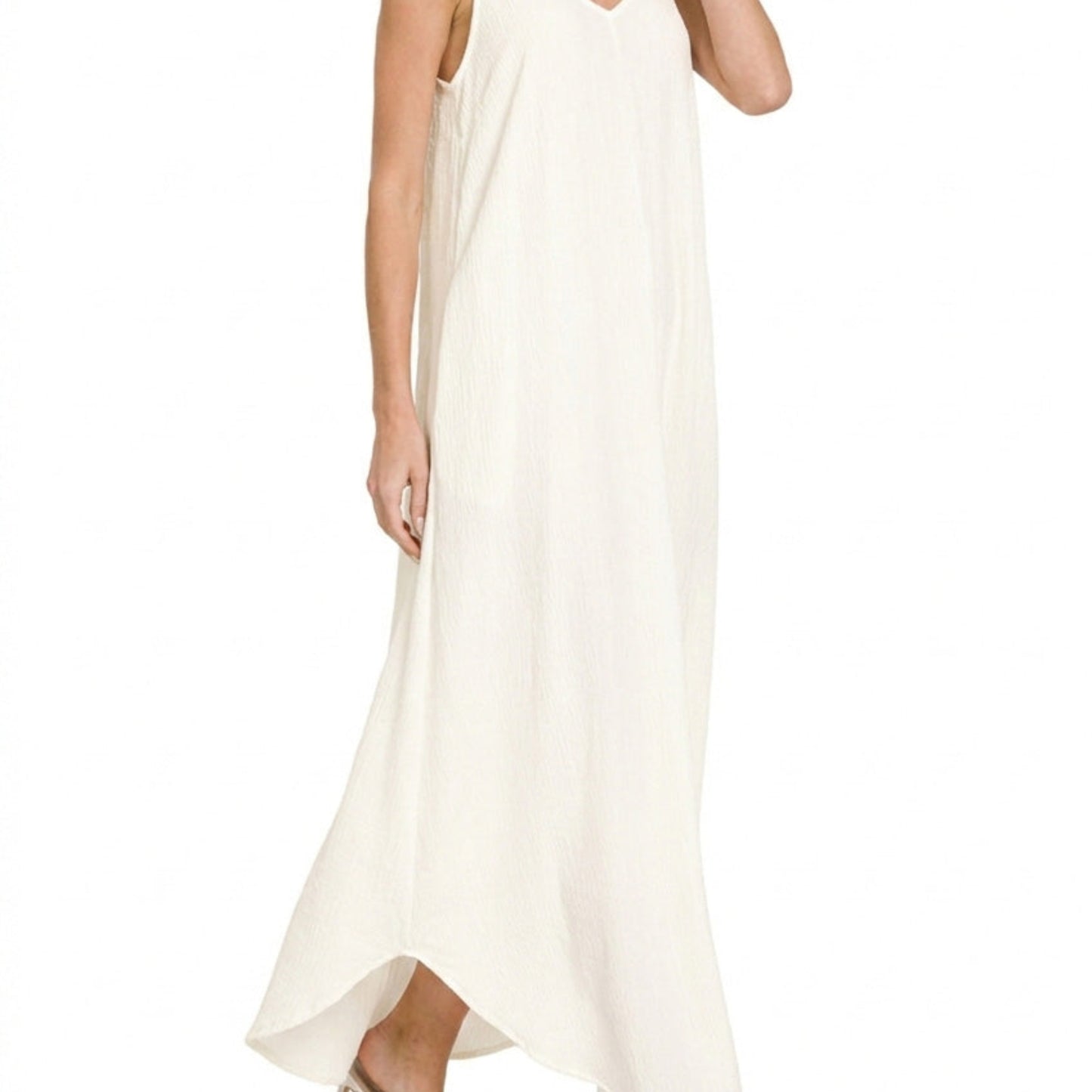 Close-up showing the side slit detail on the flowy ivory woven maxi dress.